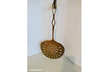 Large brass strainer spoon
